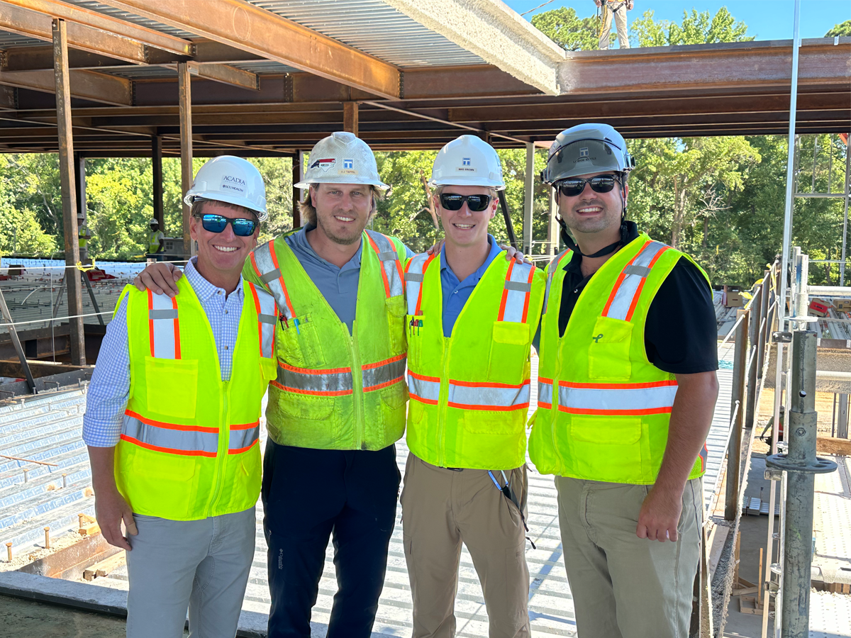 4 guys on site with vests and hard hat